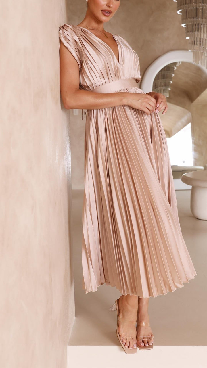 Back view of blush pleated dress with tie closure and open back