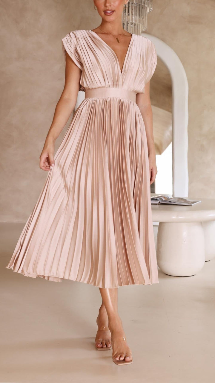 Side view of blush satin pleated dress with cap sleeve design