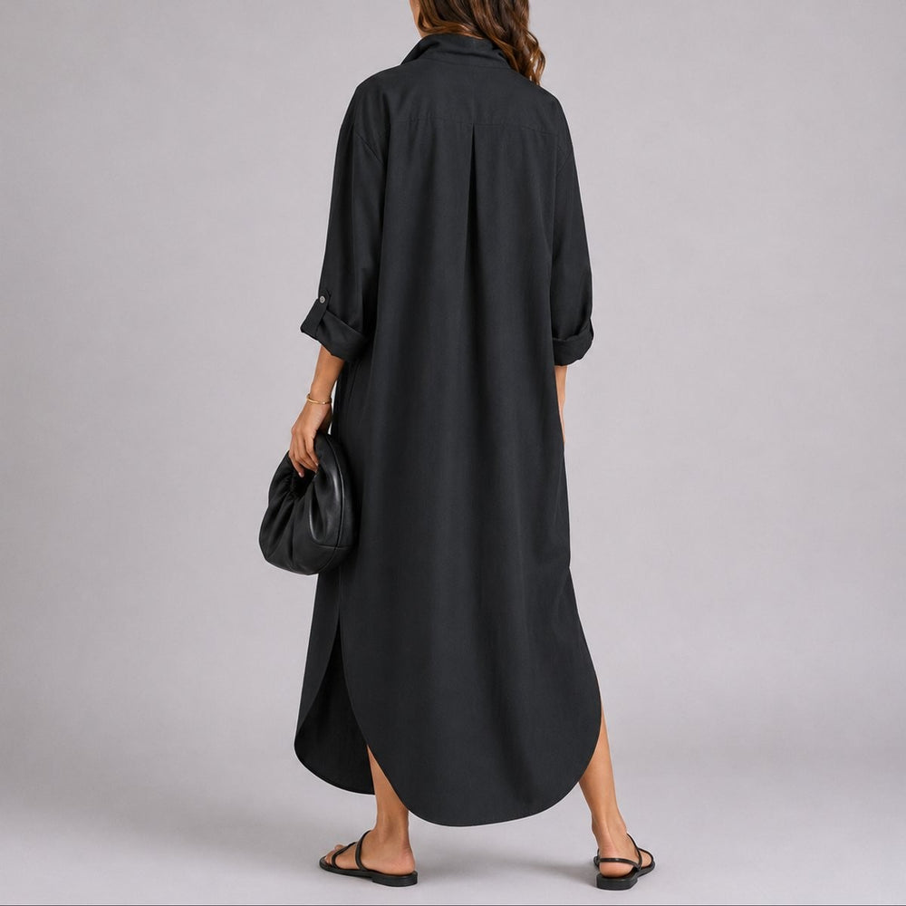 Back view of black linen maxi shirt dress showing pleated yoke and hem slit