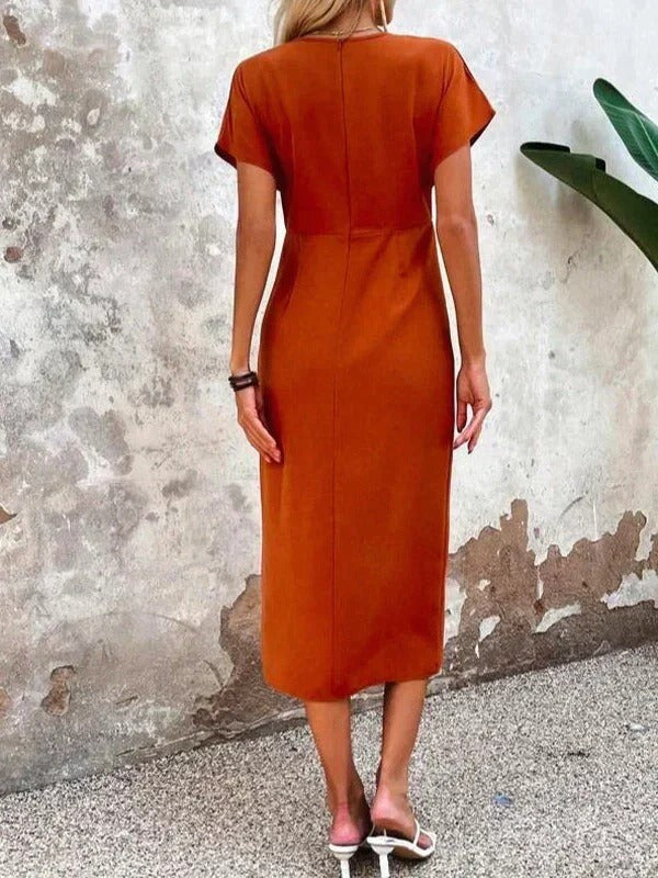 back view of rust orange midi dress with fitted waist seam
