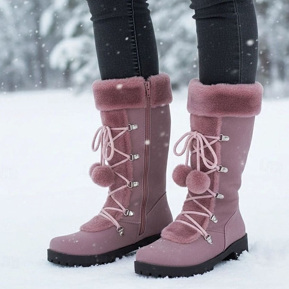 dusty pink mid-calf snow boots with fur trim and pom-pom accents