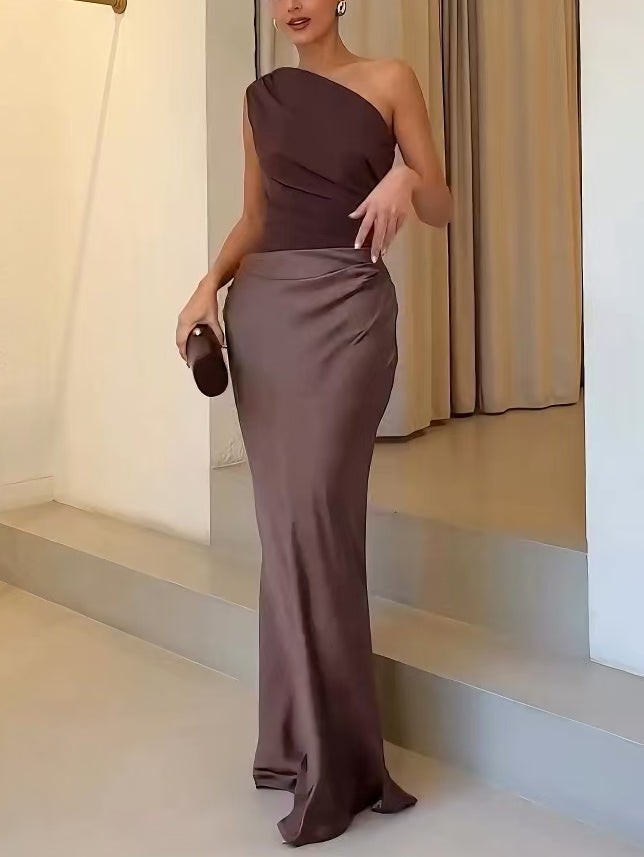 close-up view of ruched waist detail on brown one-shoulder gown