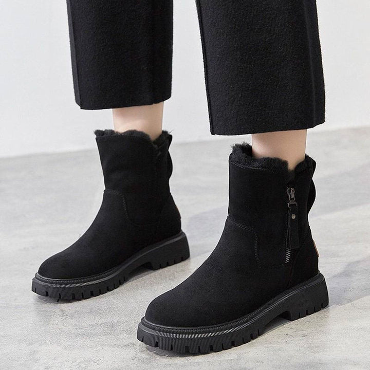 Black suede fleece-lined ankle boots with side zipper on model