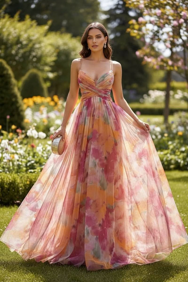 Pink and orange floral print A-line gown with spaghetti straps in garden setting