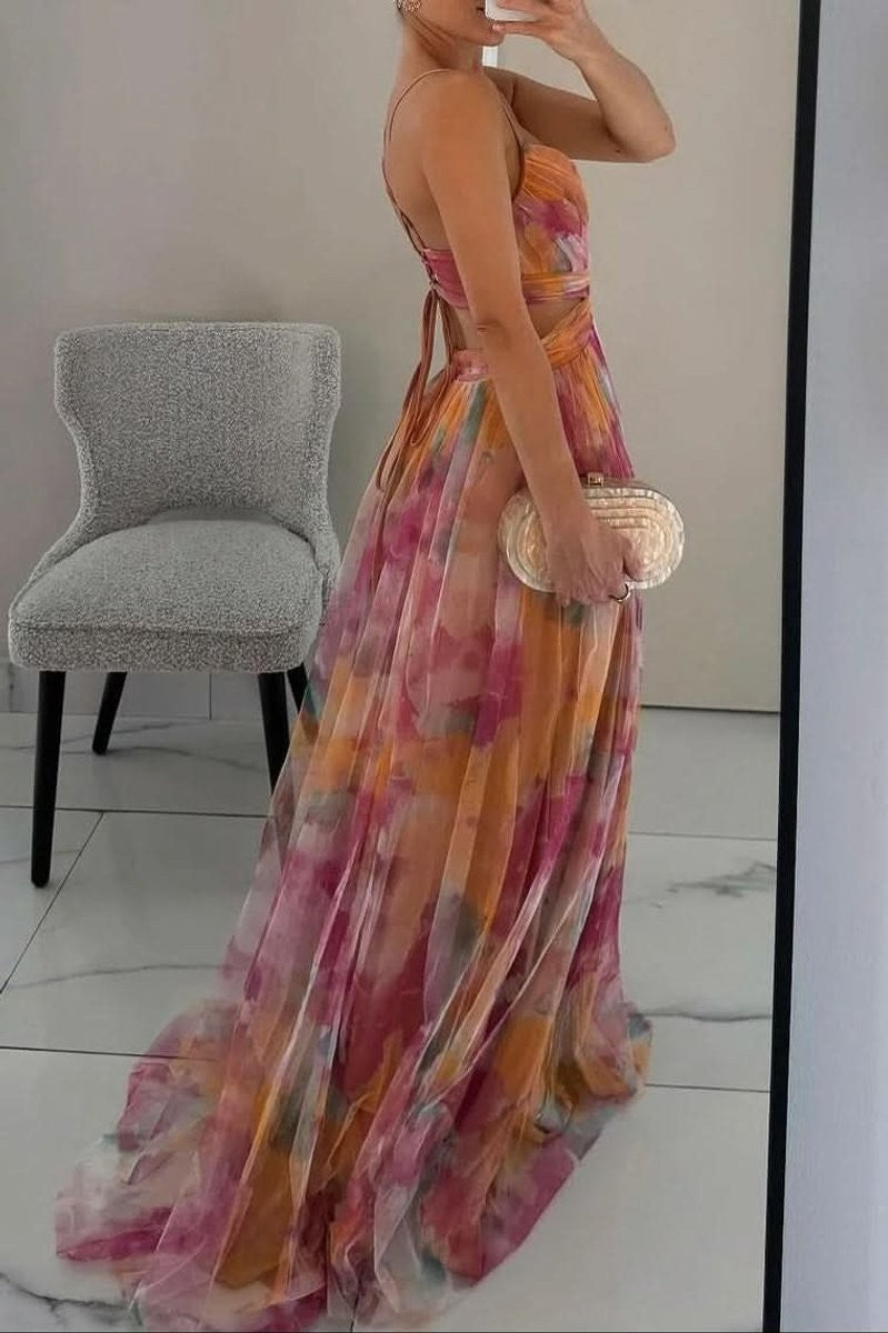 Side view of pink and orange floral maxi gown with open waist detail