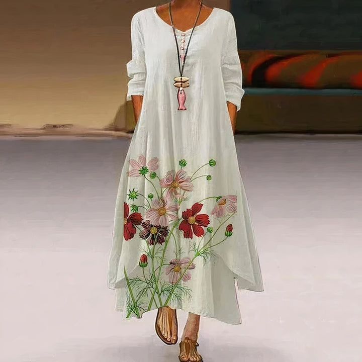 white maxi dress with red floral hem print and long sleeves