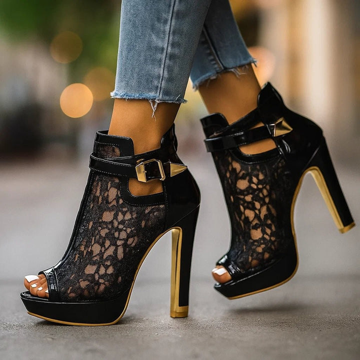 black lace stiletto ankle boots worn walking with jeans