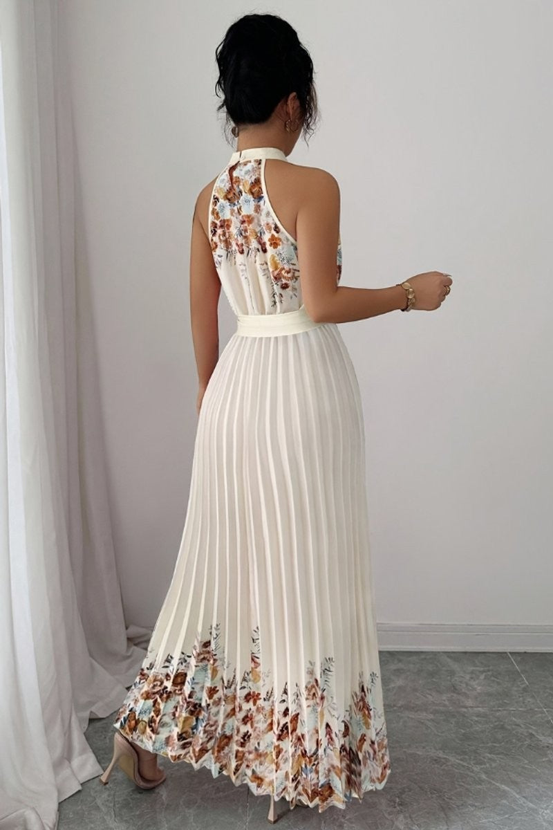Back view of cream floral halter dress showing pleated skirt detail