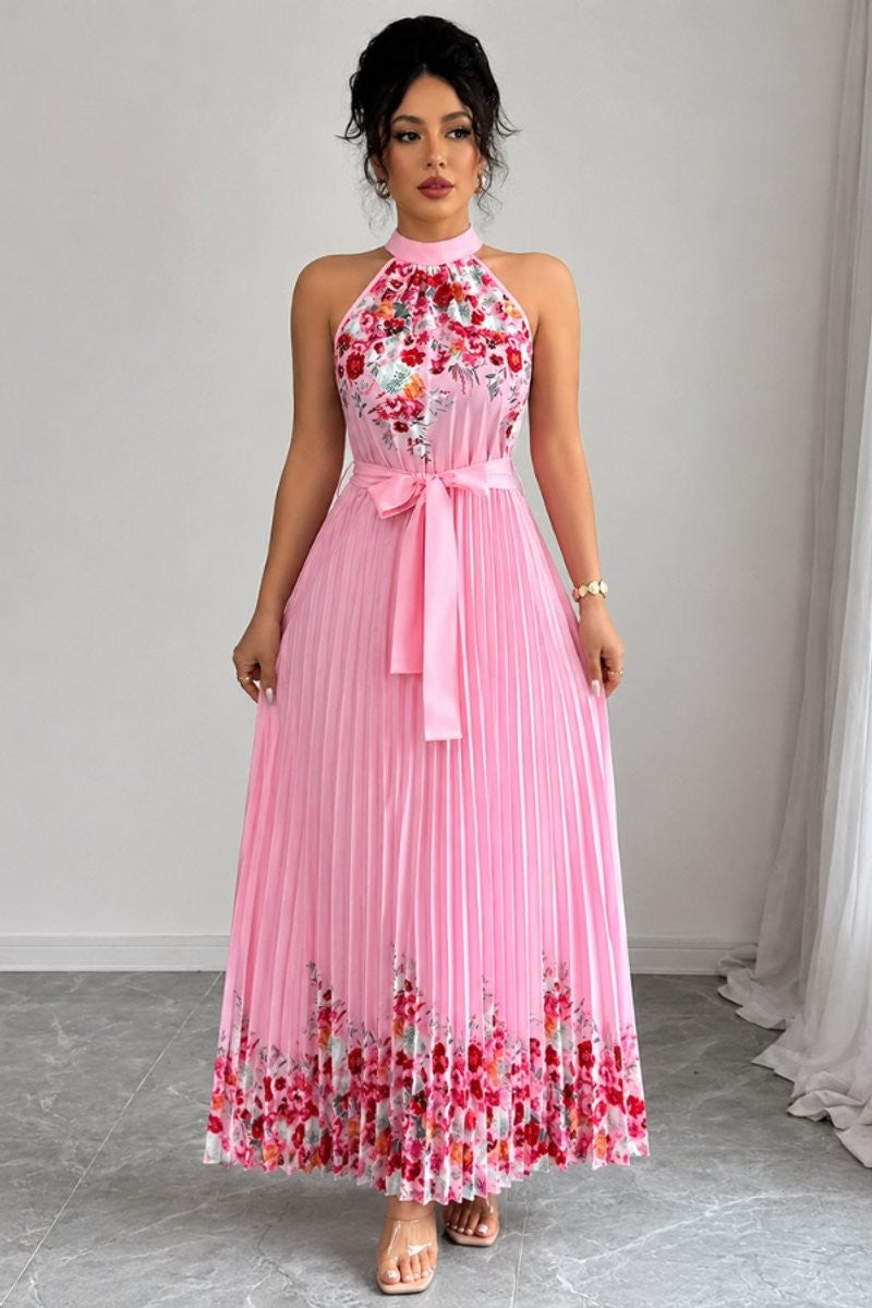 Pleated pink floral halter dress featuring belted waist and flowy skirt