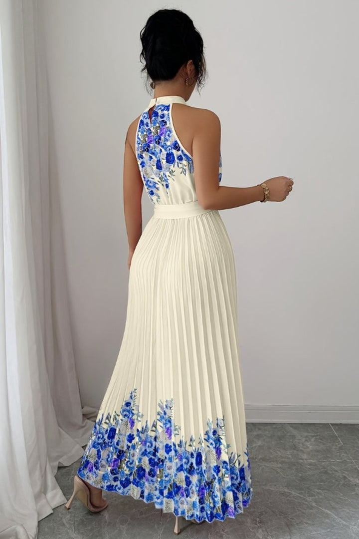 Back view of ivory blue floral halter dress with pleated skirt