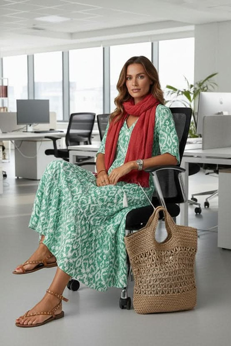 Green ikat print maxi dress paired with red scarf in office setting