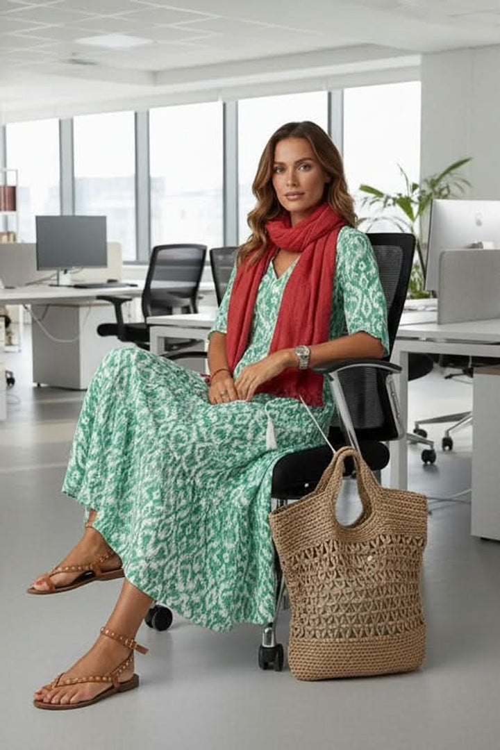 Green ikat print maxi dress paired with red scarf in office setting