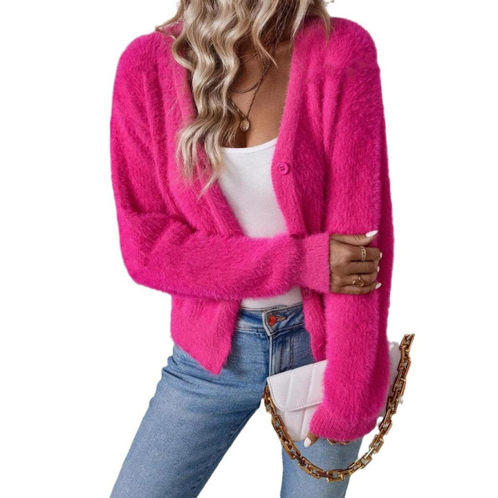 Hot pink fuzzy V-neck cardigan worn with white tank top and jeans