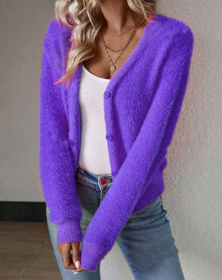 Purple fuzzy knit cardigan with button closure worn over white top