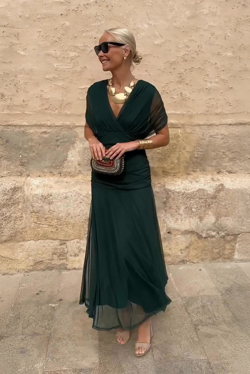 Emerald green draped V-neck maxi dress with sheer flutter sleeves and ruched waist