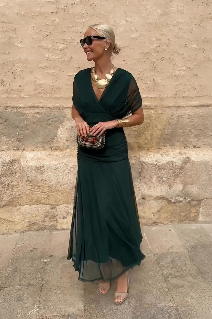 Emerald green draped V-neck maxi dress with sheer flutter sleeves and ruched waist