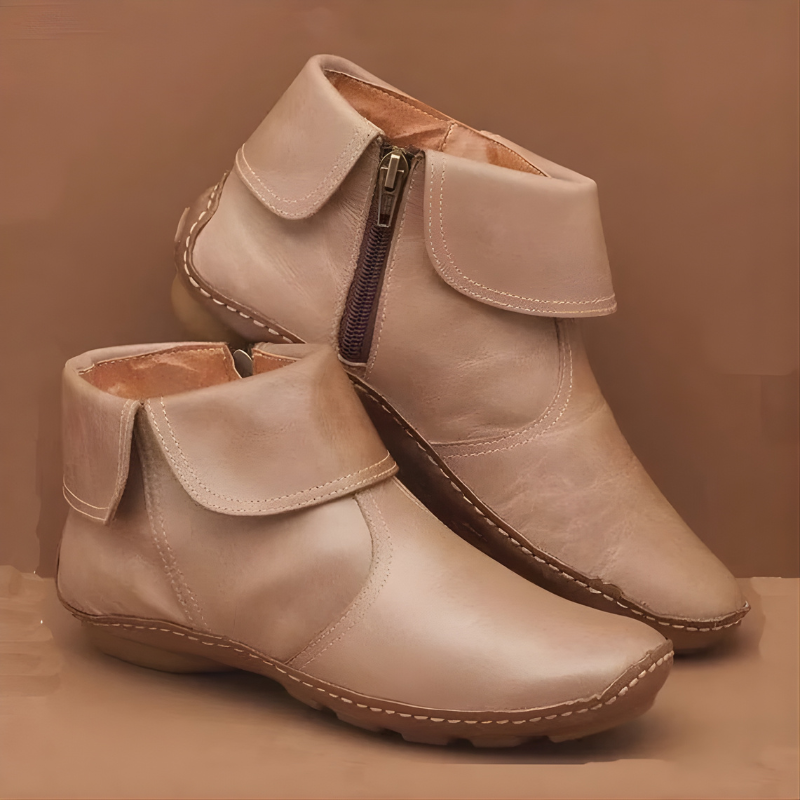 Beige leather ankle boots featuring stitched fold-over collar and zip closure