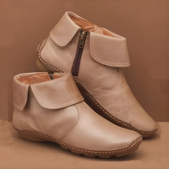 Beige leather ankle boots featuring stitched fold-over collar and zip closure