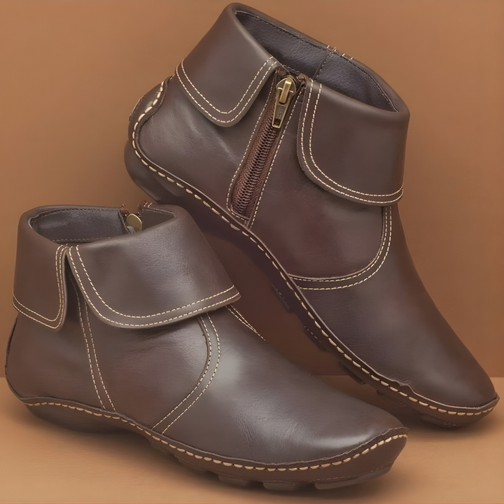 Dark brown leather ankle boots with contrast stitching and side zip design
