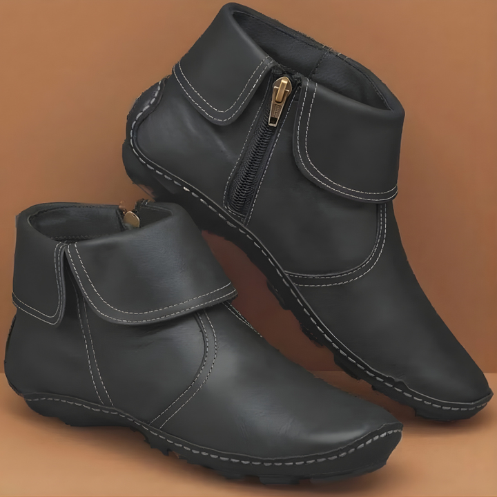Black leather ankle boots showing fold-down cuff and durable lugged sole