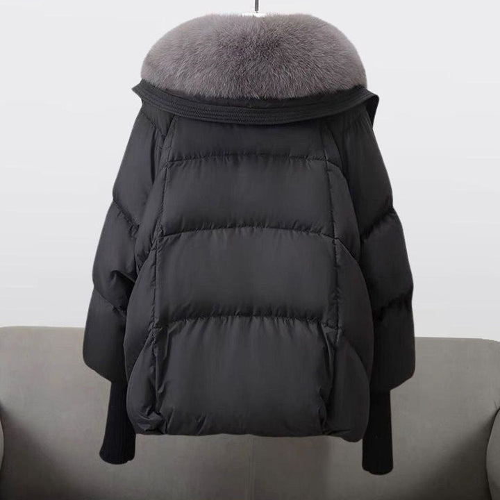 Back view of black puffer coat with gray fur trim hood