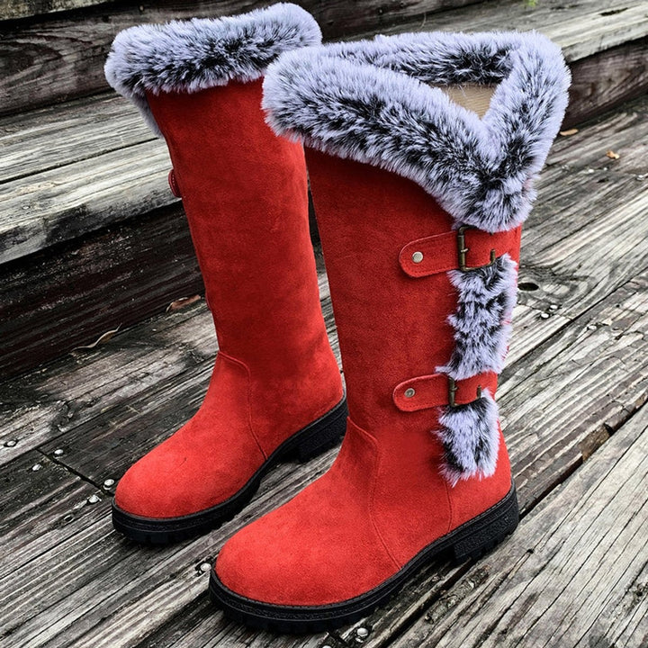Red suede knee-high boots with fur-lined tops and buckle straps