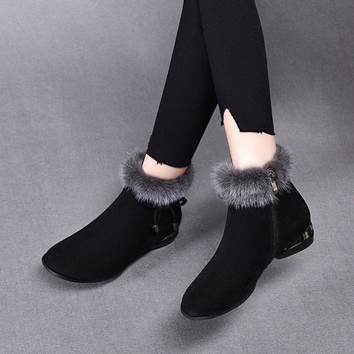 Black suede ankle boots with fox fur trim and bow detail