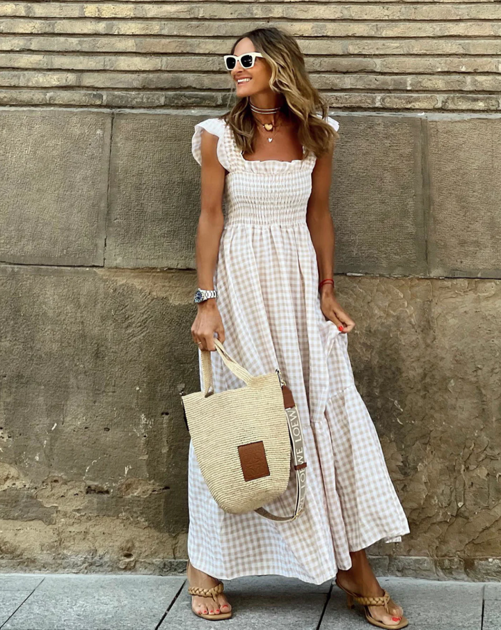 beige gingham smocked square neck maxi dress with ruffled cap sleeves and woven tote