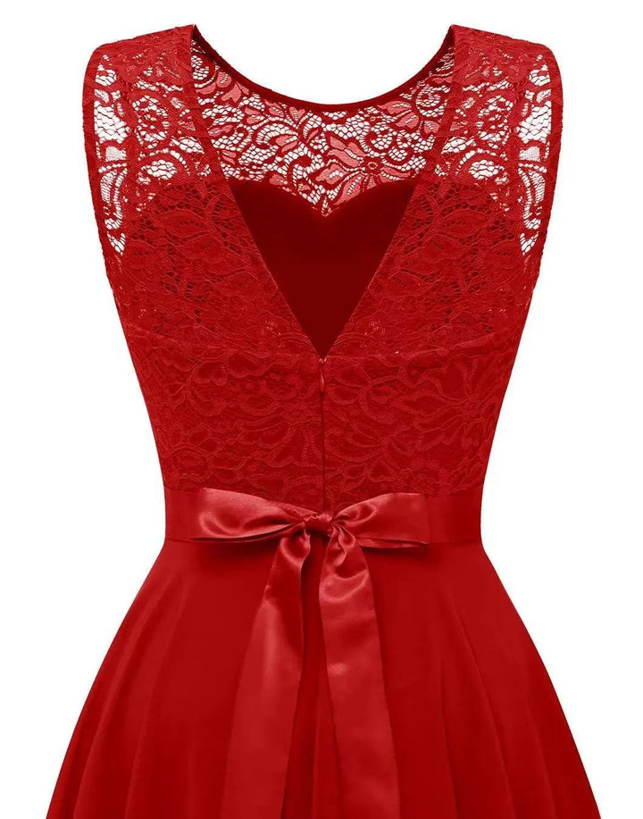 Red lace-bodice dress detail showing sweetheart cutout and ribbon waist tie