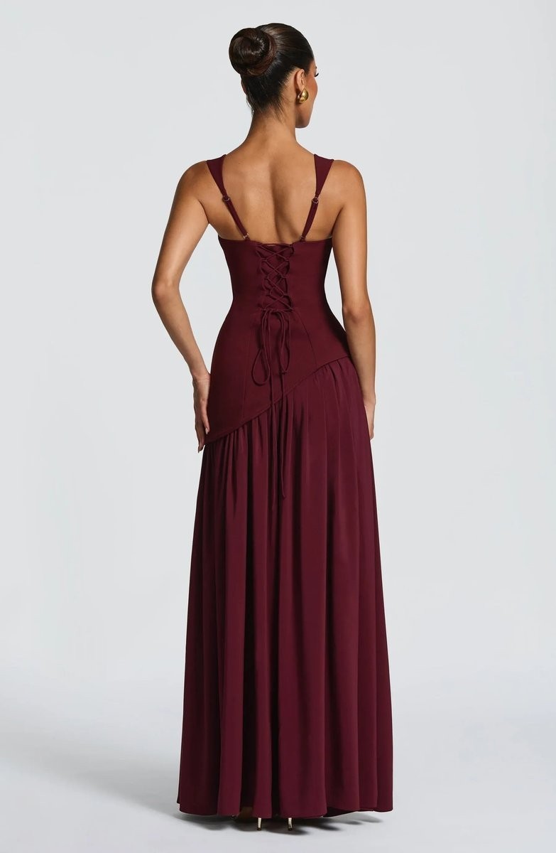 Burgundy evening gown back view with lace-up bodice and flowing maxi skirt