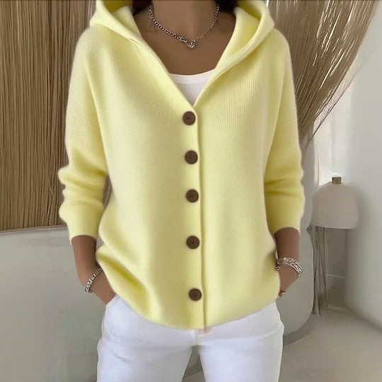 Pale yellow knit hooded cardigan with long sleeves and buttons