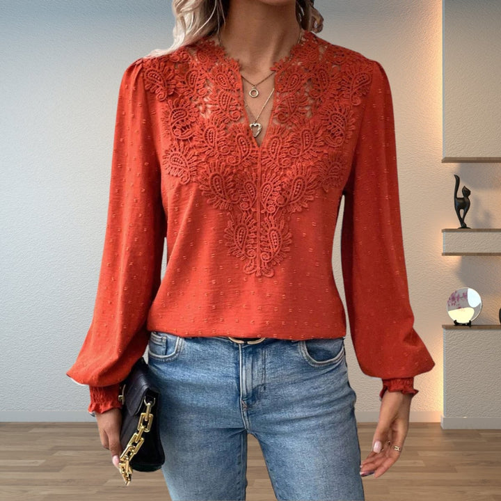 Rust orange lace-bodice blouse with V-neck and long sleeves, front view