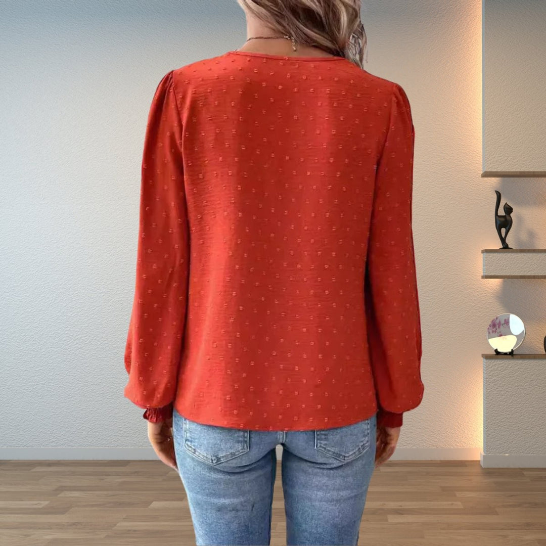 Rust orange textured blouse with balloon sleeves and smocked cuffs, back view