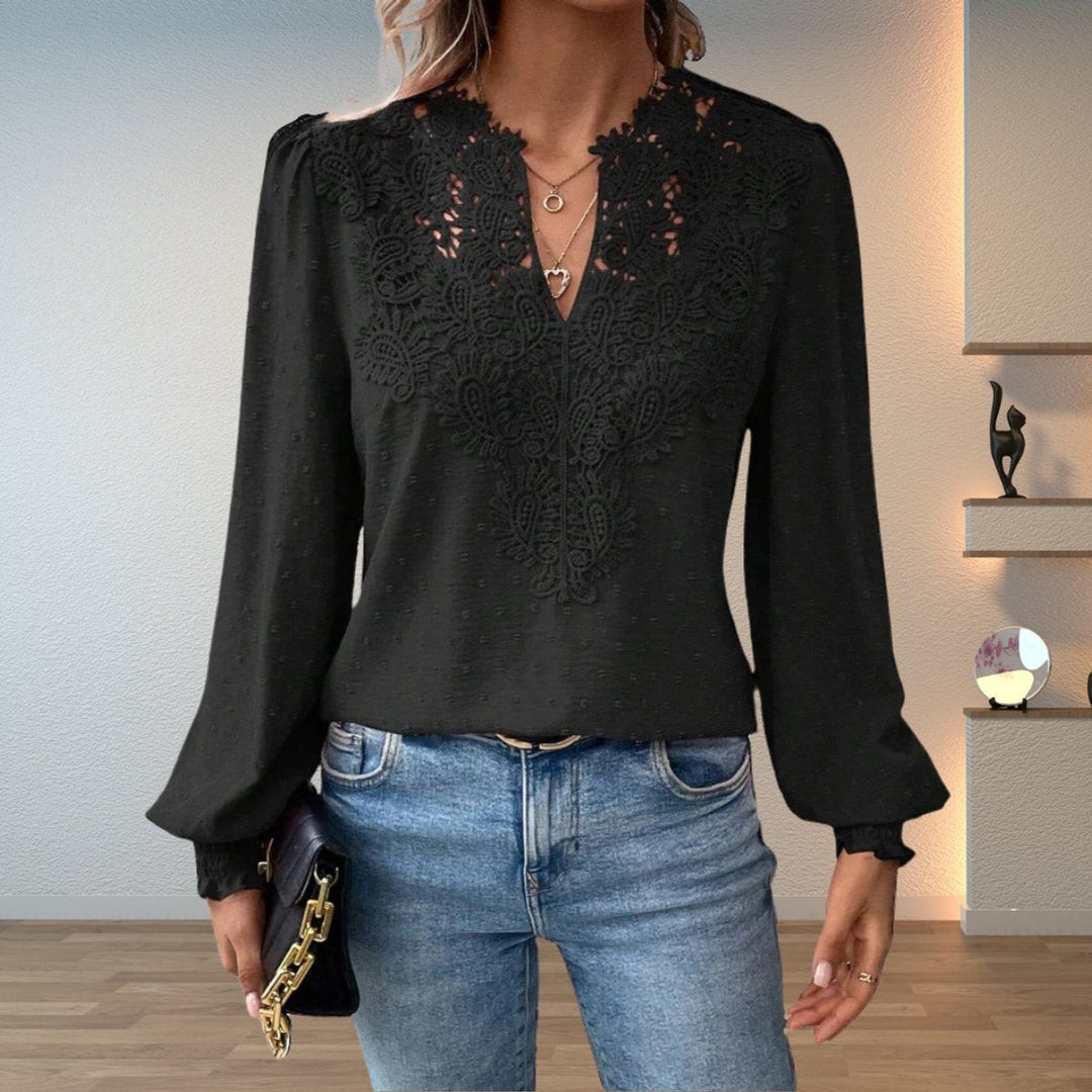 Black lace-bodice V-neck blouse with long sleeves paired with denim jeans