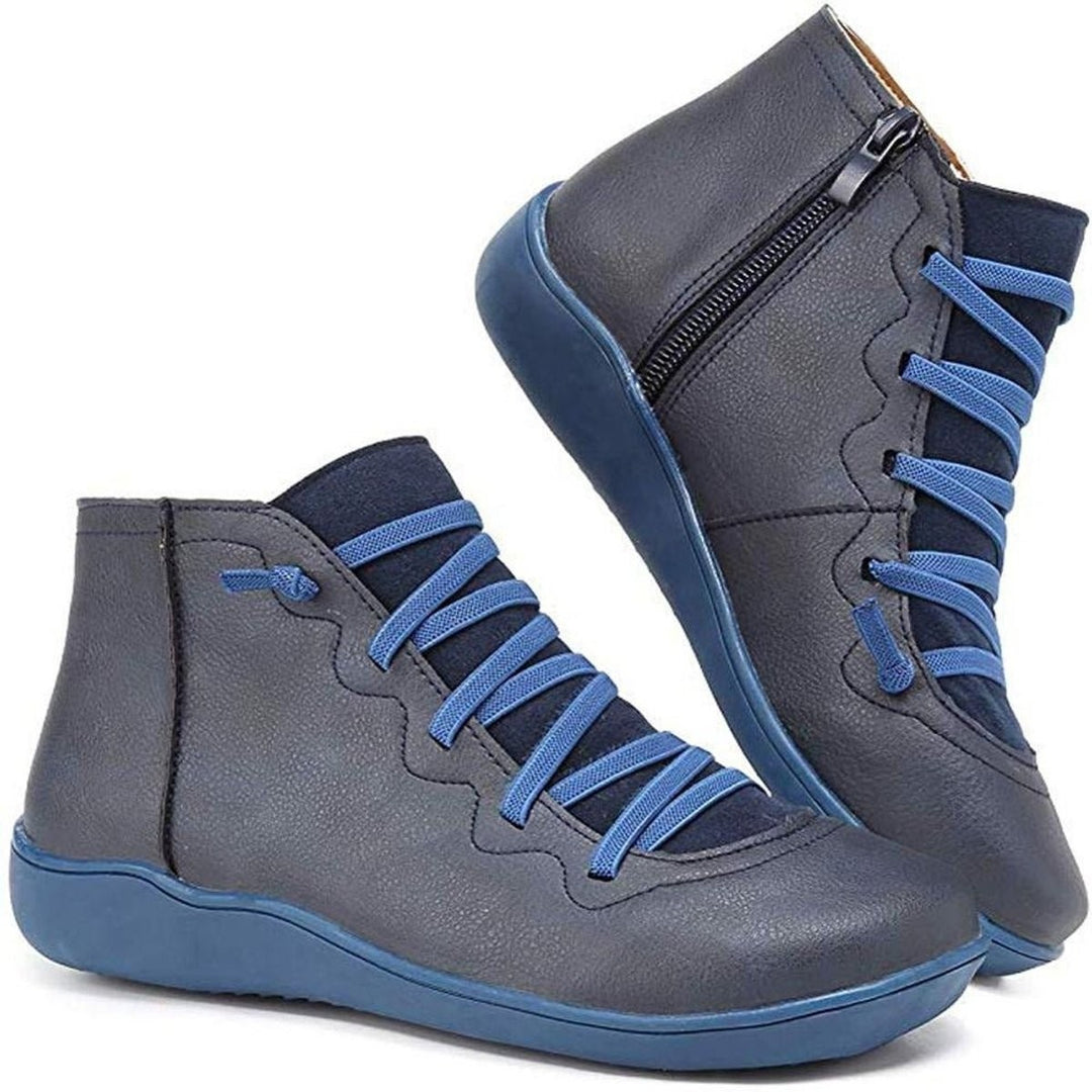 Navy leather ankle boots with blue crisscross laces and side zip