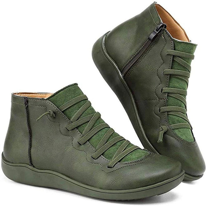 Olive green leather ankle boots with lace-up detail and side zipper