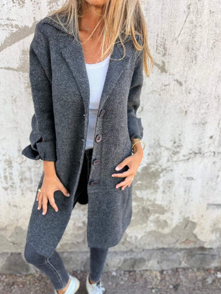 charcoal gray longline button-up coat with lapel collar and side pockets