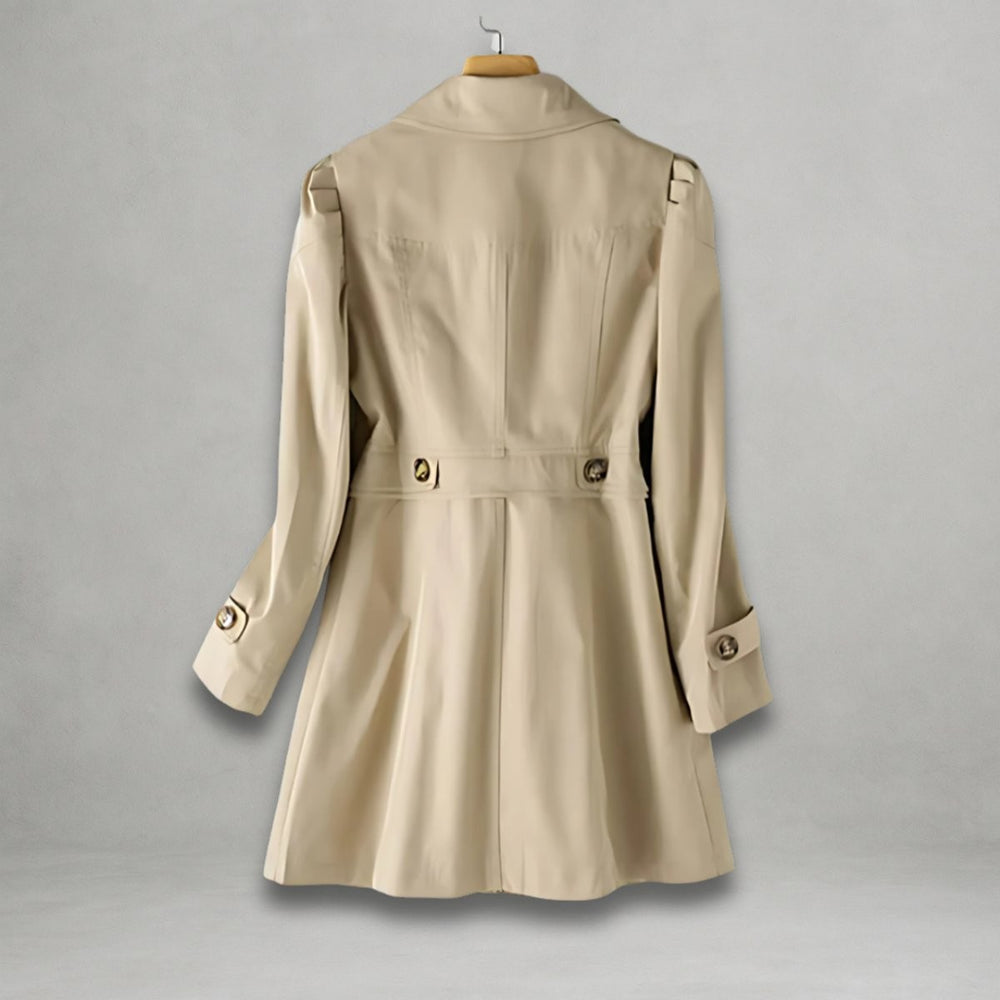 Back view of tan trench coat showing tailored waist and button tabs