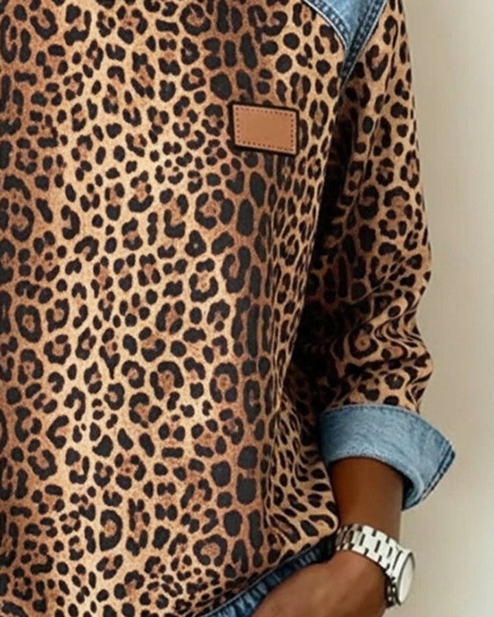 Side view of leopard print sweatshirt showing denim cuff and leather patch