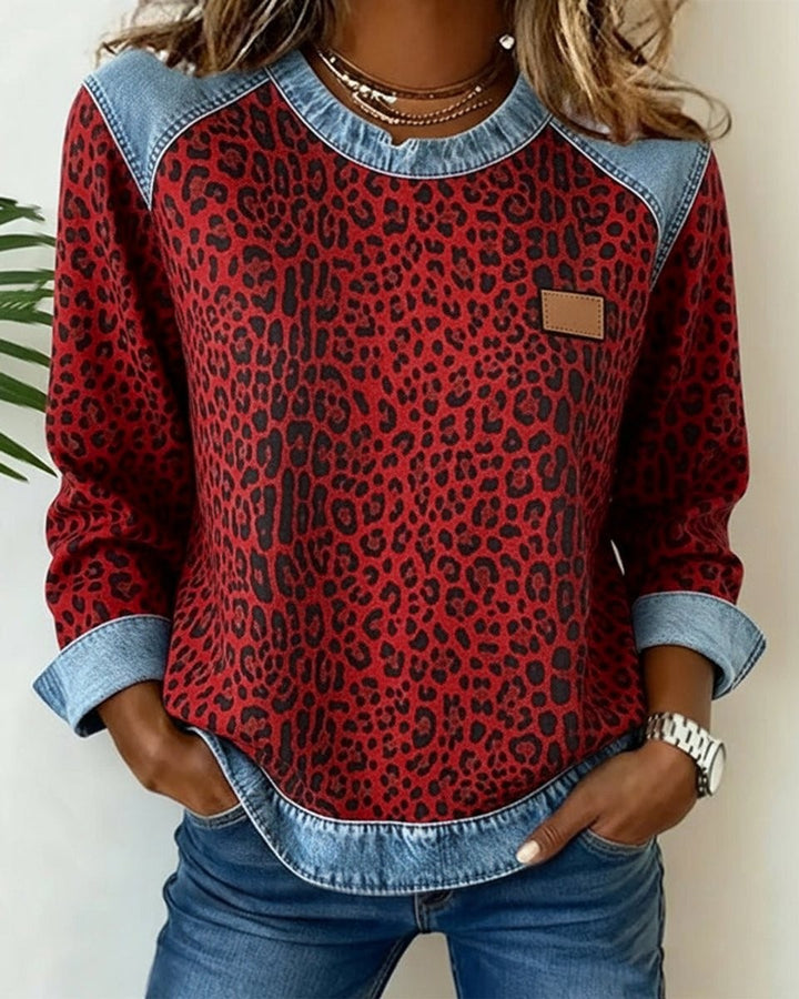 Red leopard print pullover sweater with denim raglan sleeve accents