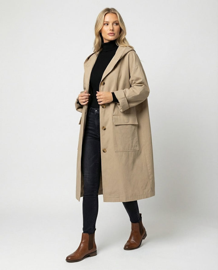 Oversized beige hooded trench coat styled with black turtleneck and jeans