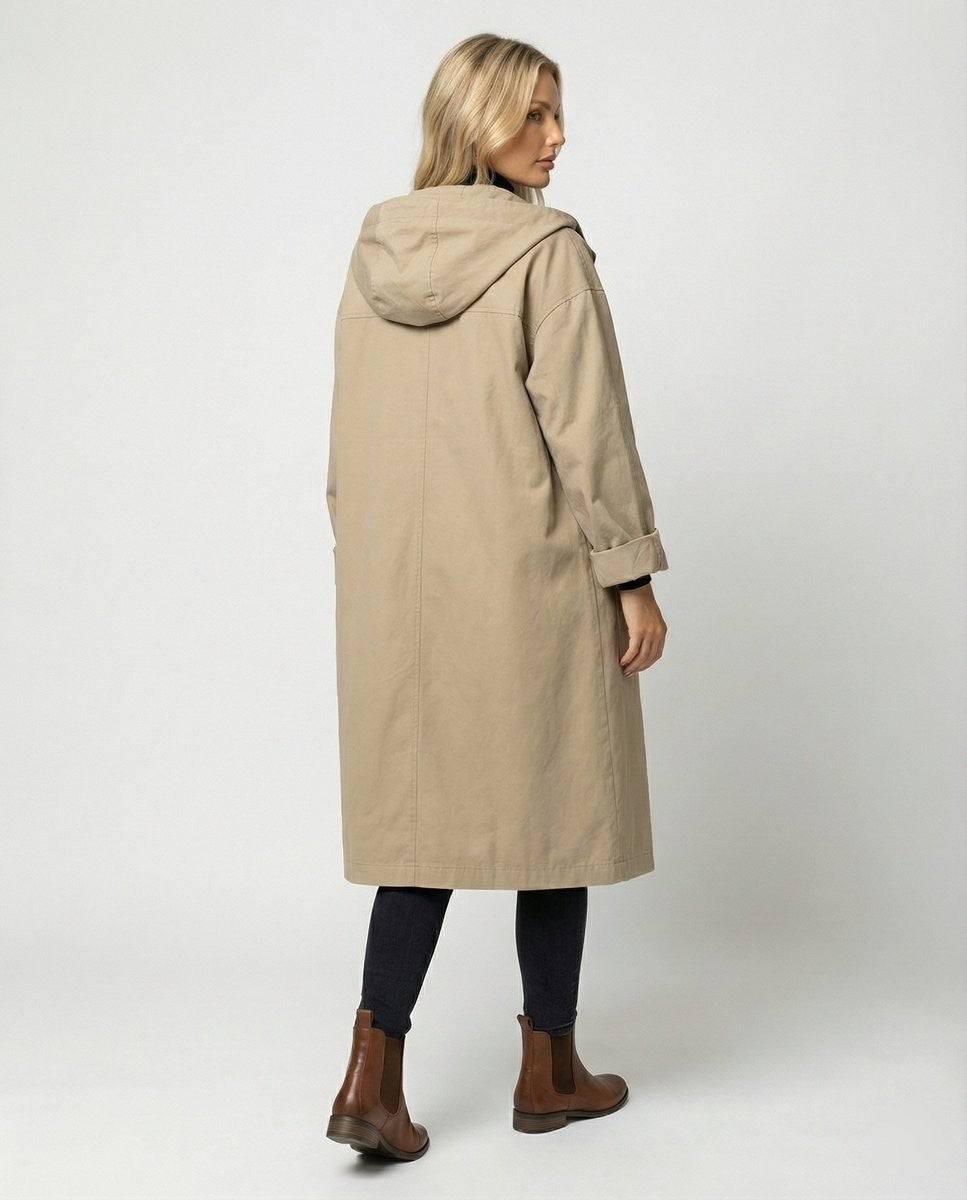 Back view of long beige hooded trench coat with dropped shoulders