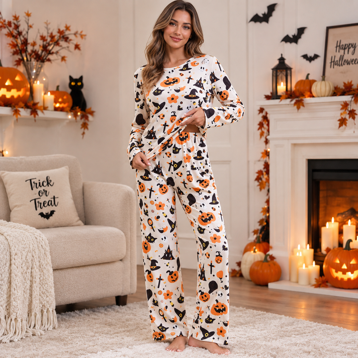 Woman wears cream pumpkin-print pajama set in cozy Halloween-decorated living room