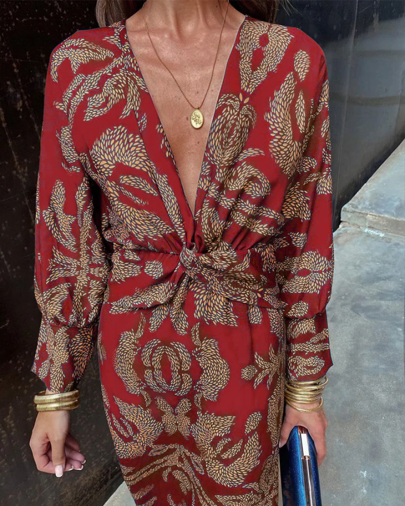 Close-up of red and gold paisley dress with twisted waist detail