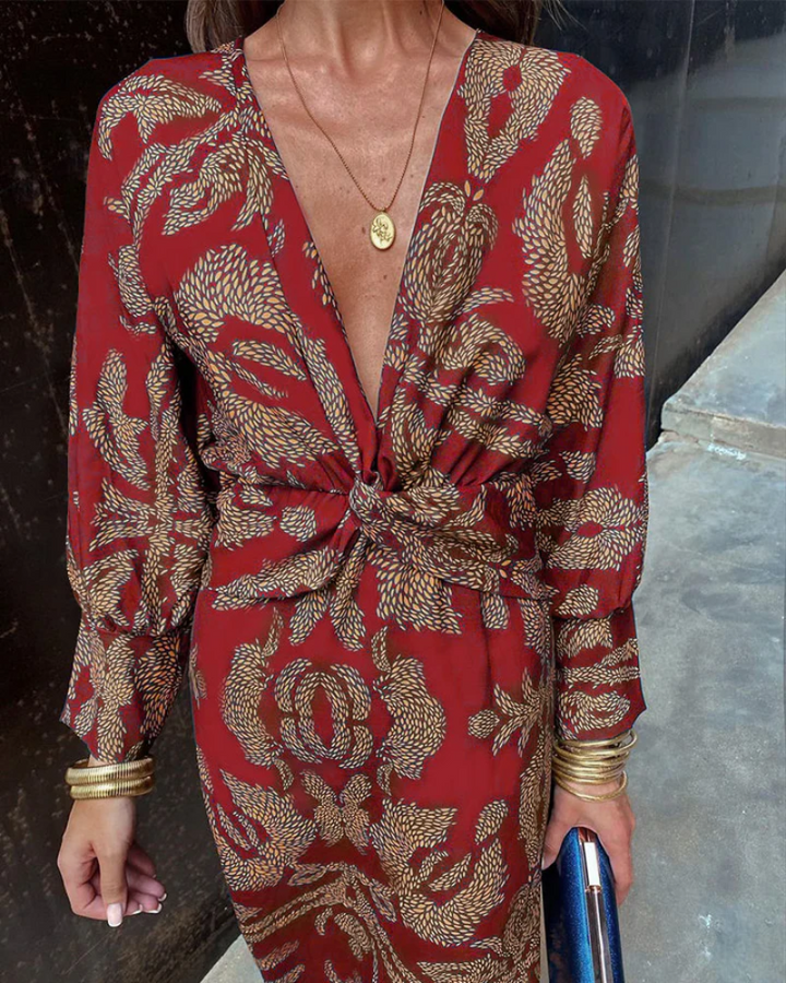 Close-up of red and gold paisley dress with twisted waist detail