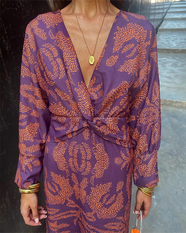 Purple and orange paisley print dress with deep V-neck and twist-front waist