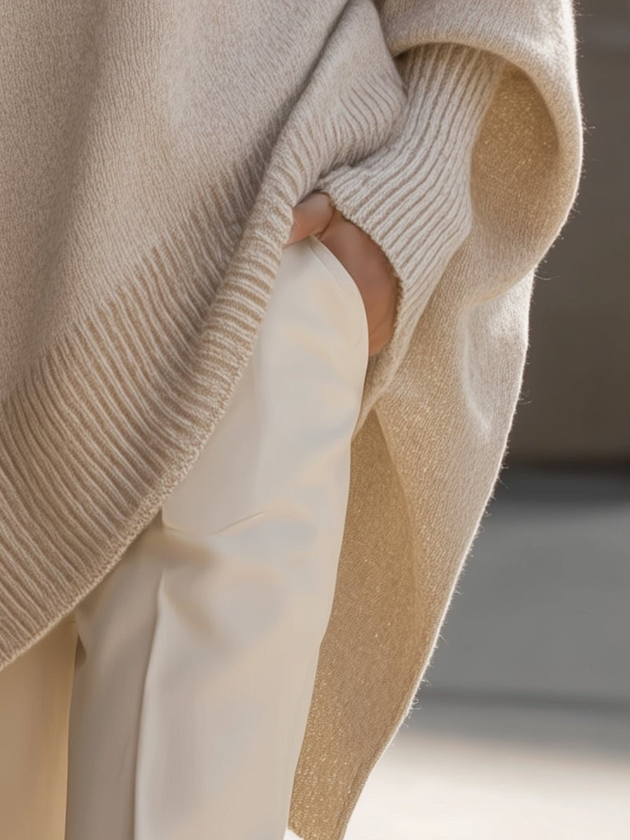 Close-up of hand in pocket showing ribbed cuff on beige knit sweater