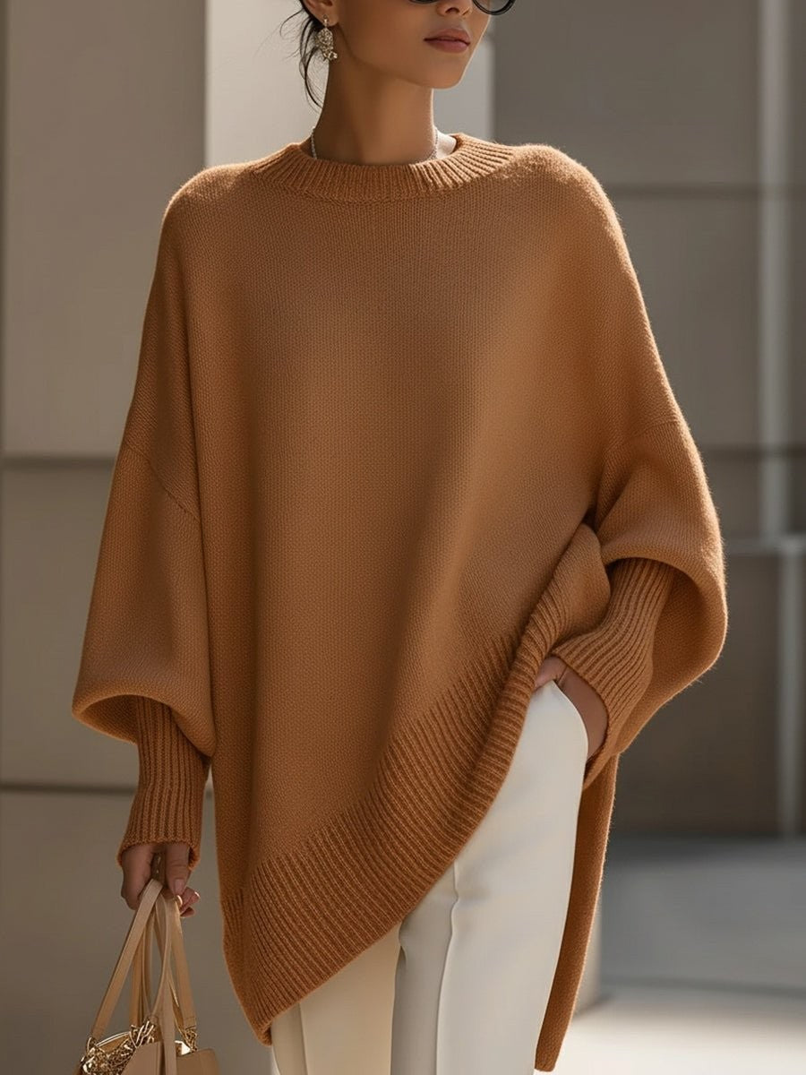 Camel oversized batwing knit sweater with ribbed hem over white pants
