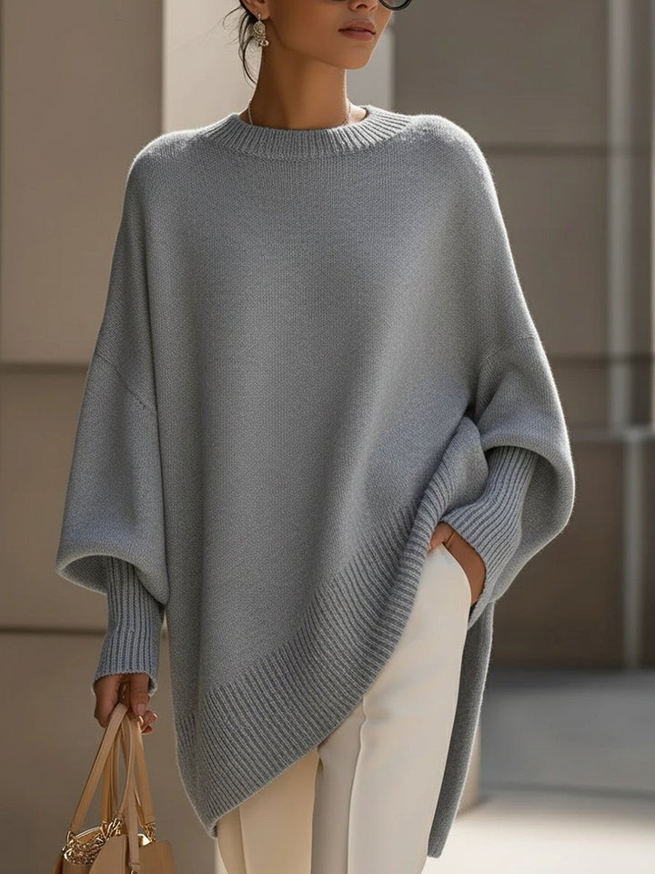 Gray oversized batwing knit sweater with ribbed asymmetric hem and crew neck