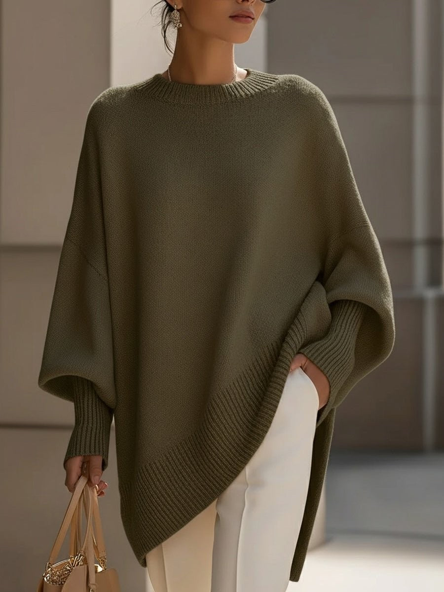 Olive green oversized knit sweater with batwing sleeves and ribbed asymmetric hem